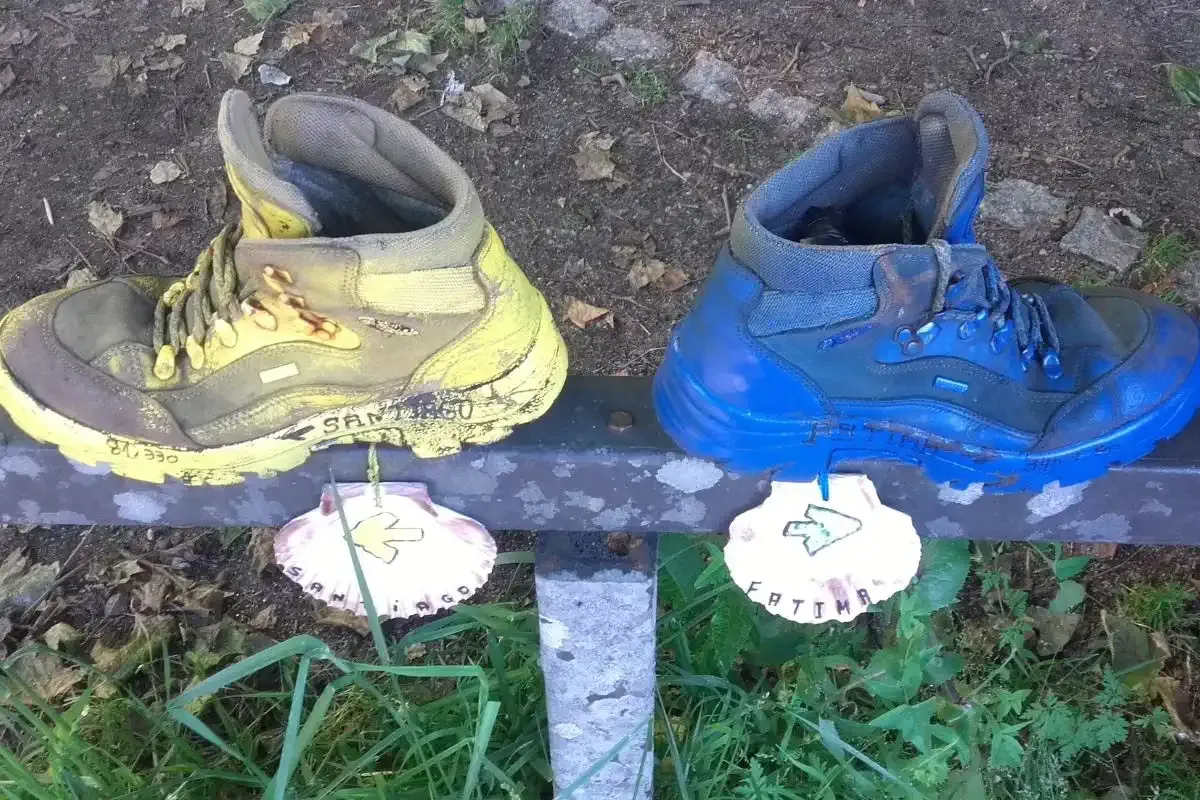 Botas de peregrino en el Camino de Santiago desde Tui señalizando el camino