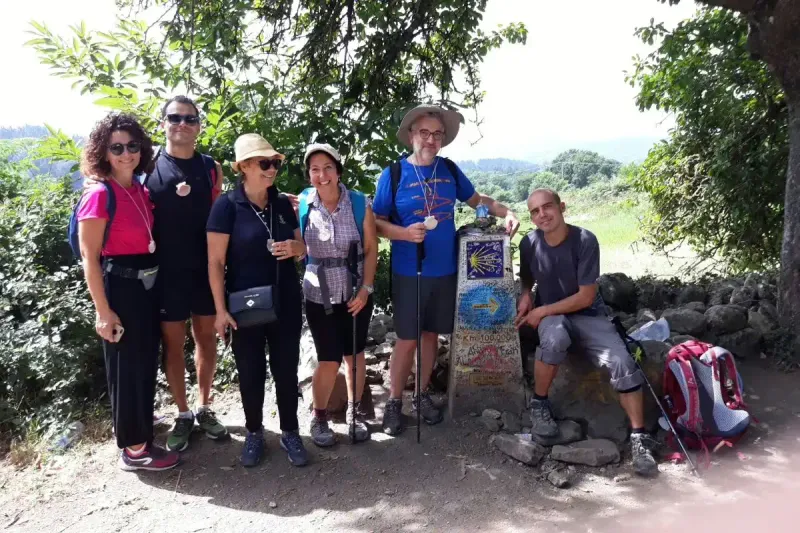 Grupo de Peregrinos junto al Mojón del KM 100